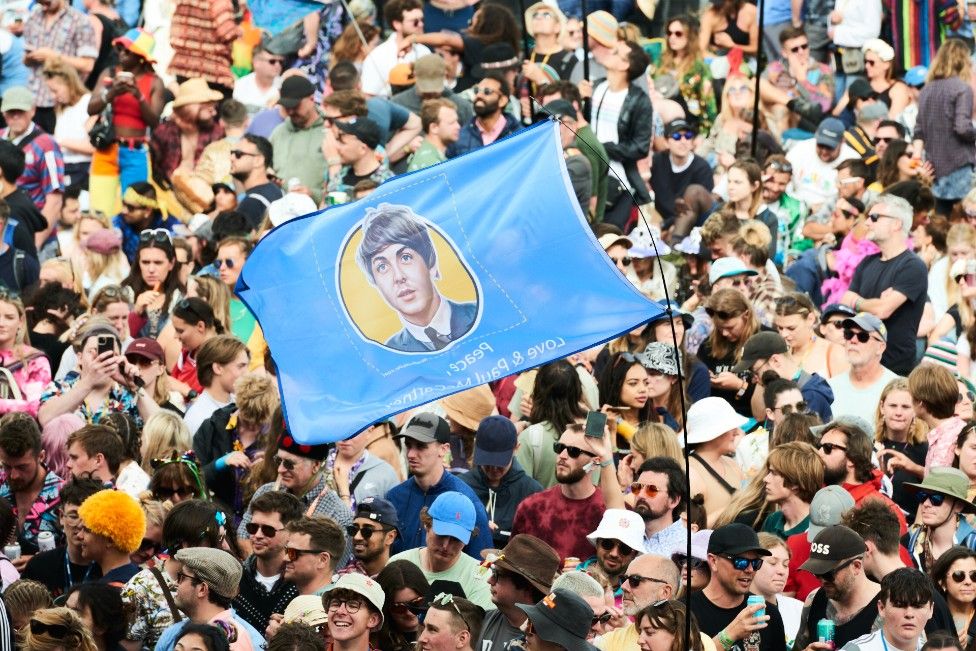 Fans dressed up in Sgt Pepper outfits and waved flags of Sir Paul's face