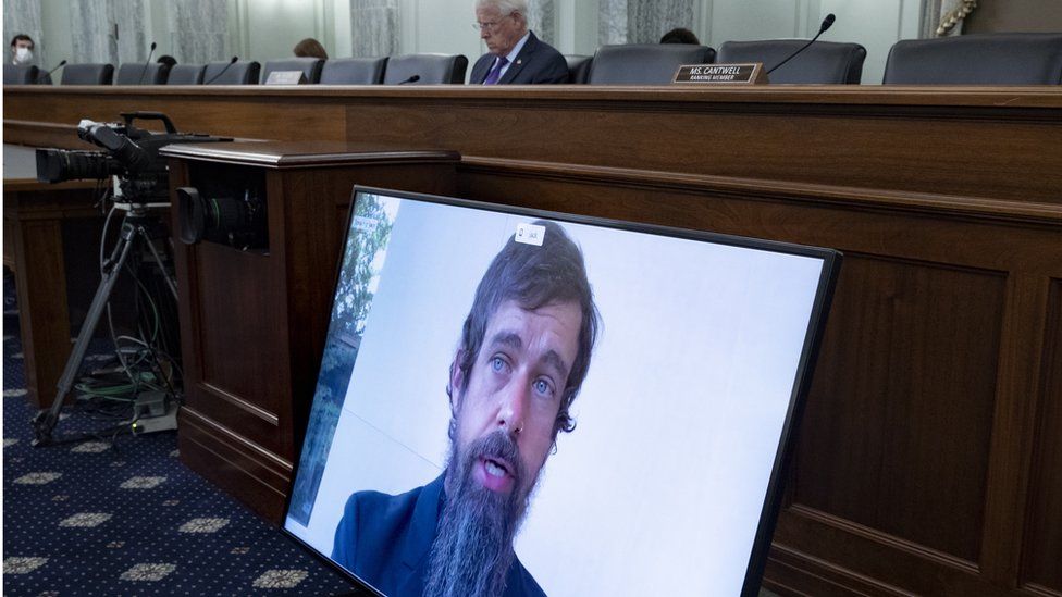 CEO of Twitter Jack Dorsey appears on a monitor as Chairman of the Senate Commerce, Science, and Transportation Committee Roger Wicker (Back) listens