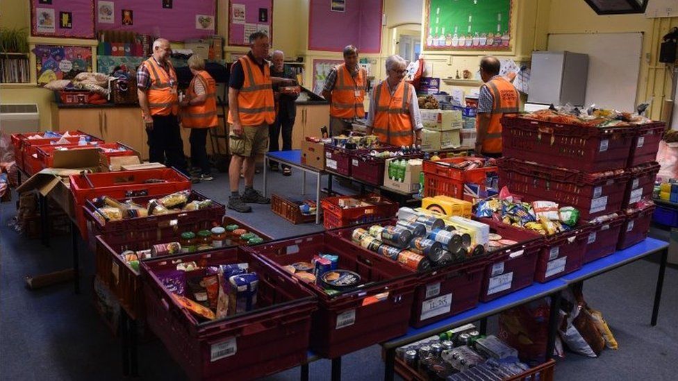 Volunteers with food to give to returning residents