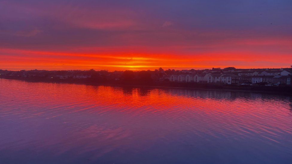 Image shows spectacular sunrise over Hayle