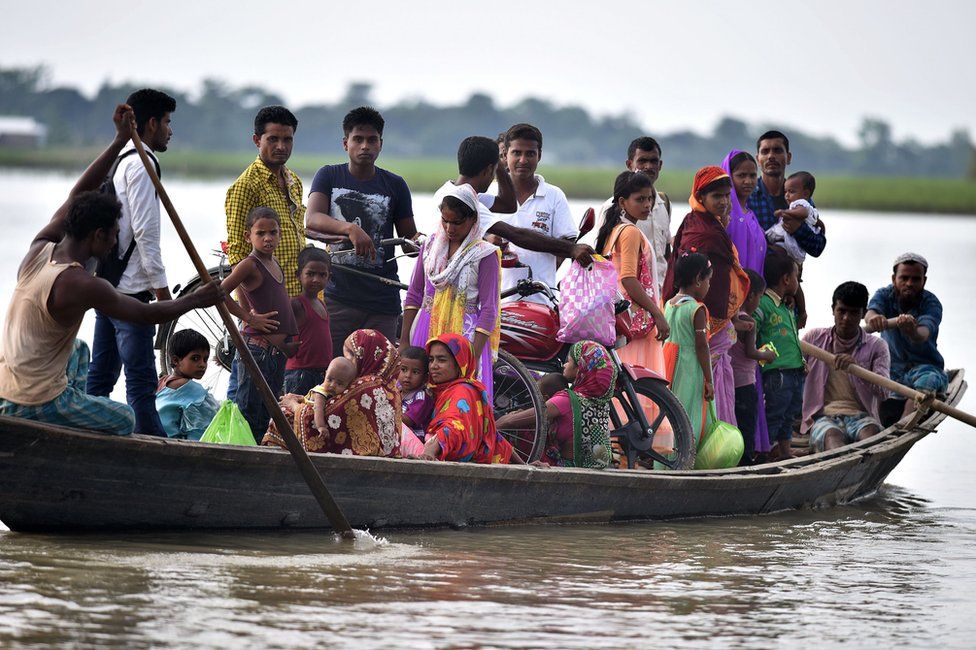 Villagers in Assam travel by boat during floods in 2016