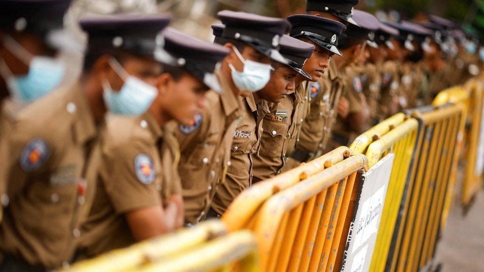 Policemen stand guard at a barricade outside the Parliament building