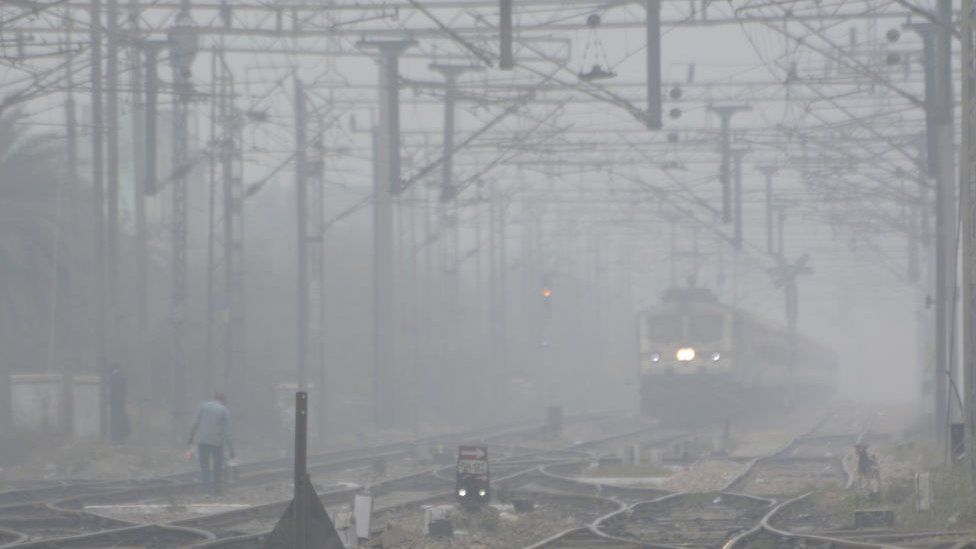 Train moving at Kot village railway line amid thick fog on January 4, 2023 in Ghaziabad, India. The India Meteorological Department (IMD) has predicted prevalence of severe cold weather conditions, along with dense to very dense fog over northwest India during the next four to five days. (Photo by Sakib Ali/Hindustan Times via Getty Images)