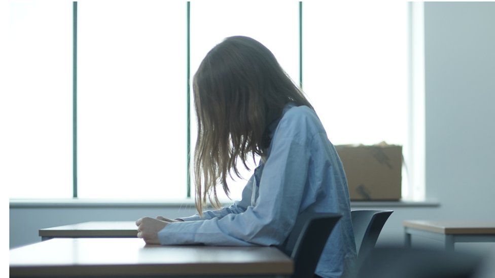 Girl sitting at school desk