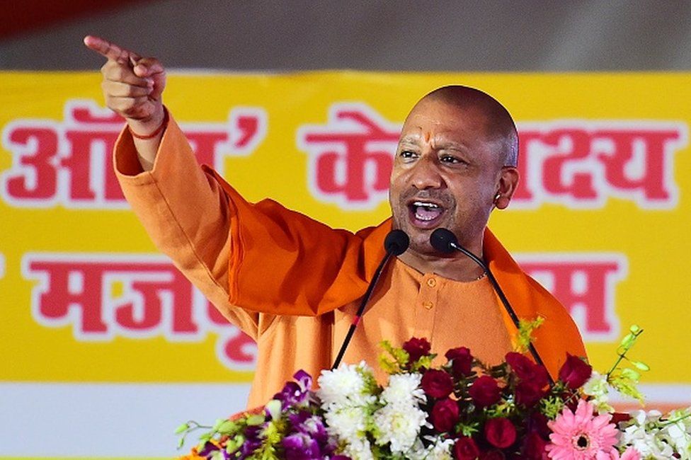 The chief minister of India's Uttar Pradesh state Yogi Adityanath addresses a public rally during the foundation stone laying ceremony of the houses to be constructed under 'Pradhan Mantri Awas Yojana', a government programme in Allahabad on December 26, 2021. (