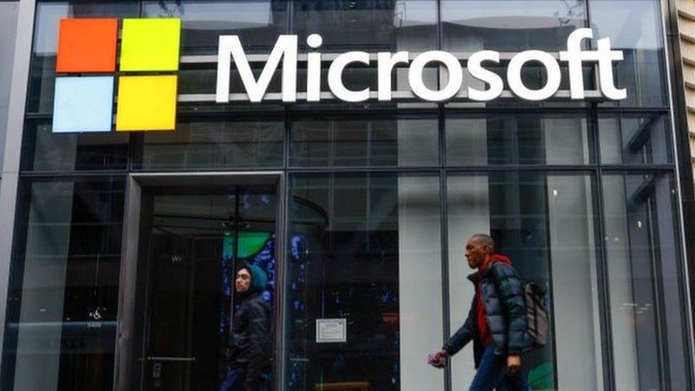 People walk past a Microsoft office