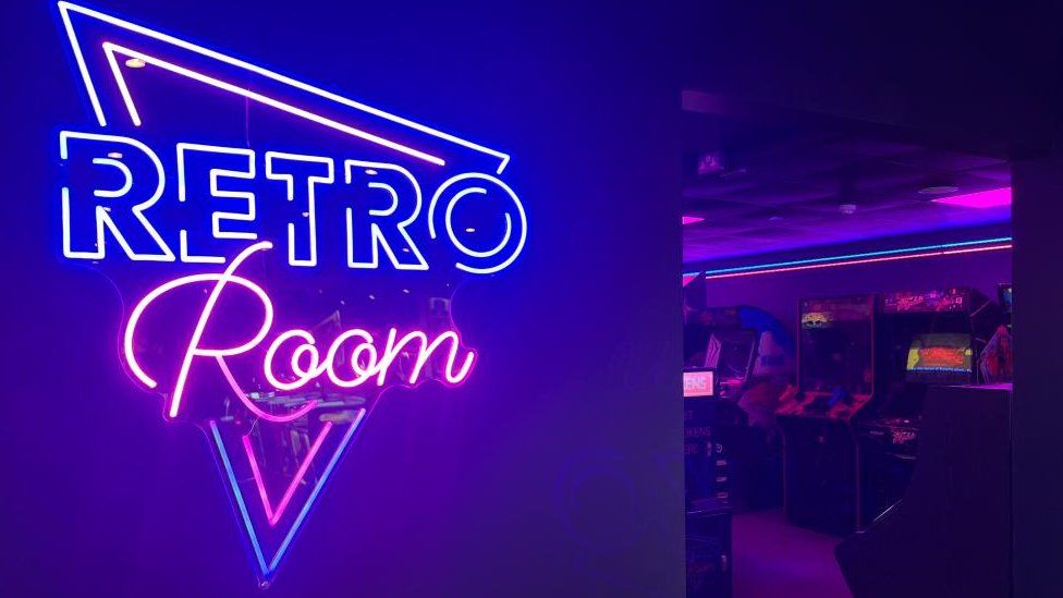 Neon sign indicates Retro Room attraction