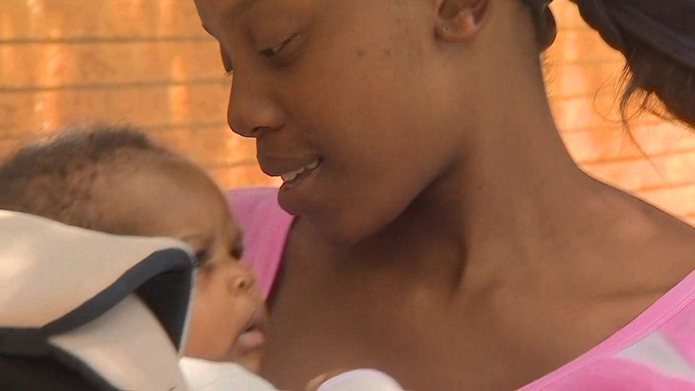 Sibongile Mngomezulu cradles her three-month old baby
