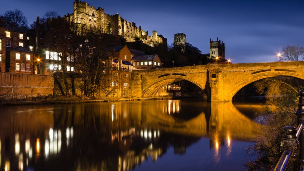 Durham City skyline reflected in river at night