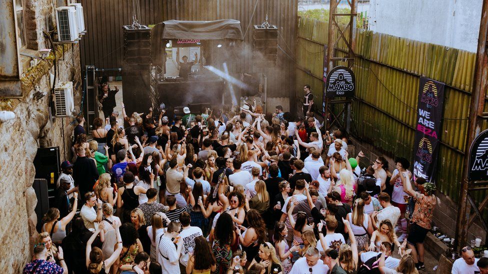 Hundreds of people dance to a live DJ set in the outdoor area at Motion in Bristol in a Cafe Mambo event