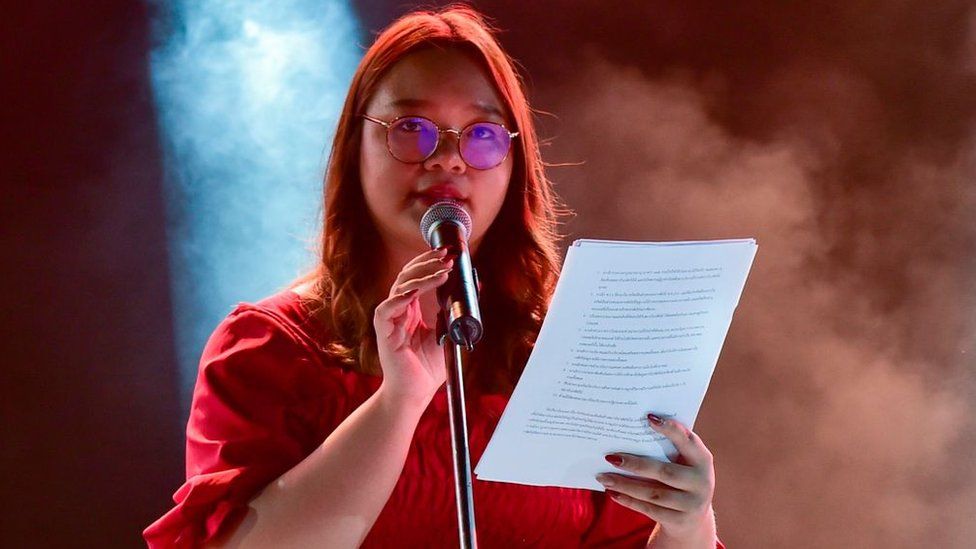Student Union of Thailand spokesperson Panusaya Sithijirawattanakul reads a list of demands