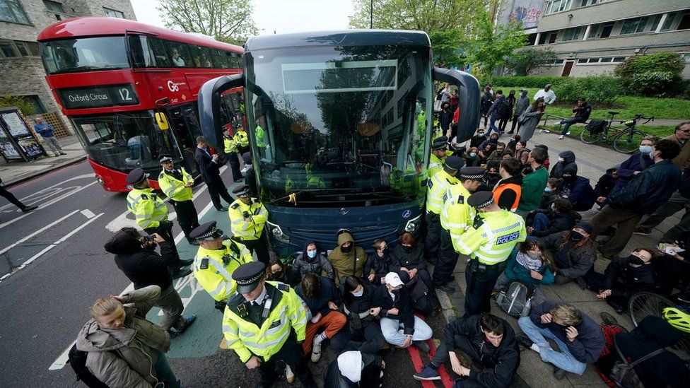 Police officers surround the coach
