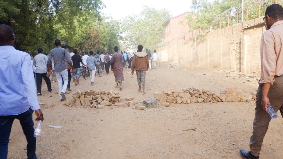 People walking along a road towards a sit-in at the military HQ in Khartoum, Sudan - Monday 8 April 2019