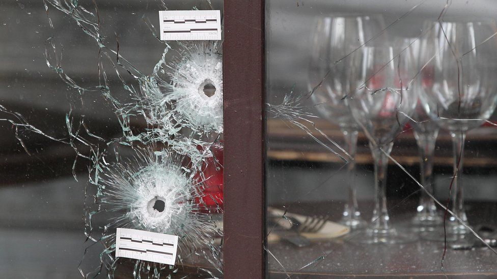Bullet holes in a window of a Paris restaurant after 13 November 2015 attacks