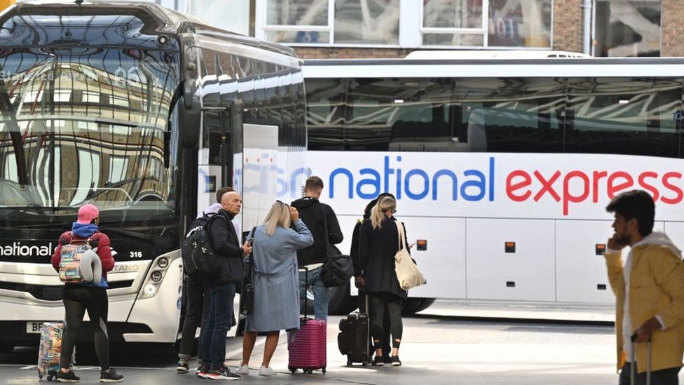People board a National Express bus