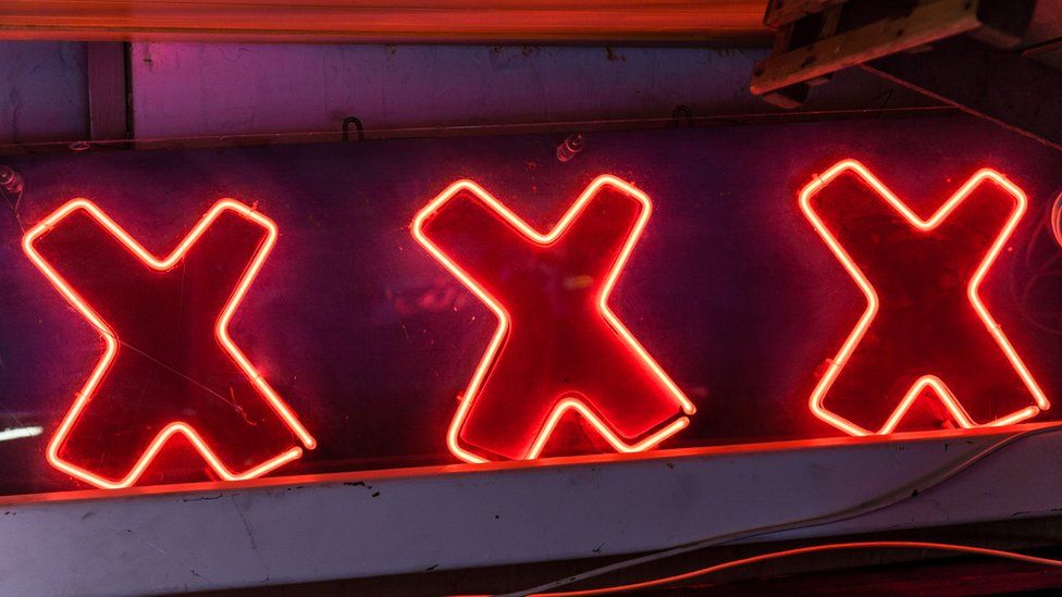 A stock image of a neon sign reading XXX