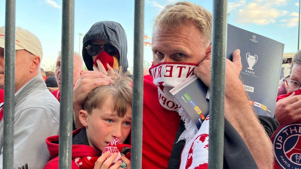 Liverpool fans react as they queue to access Stade de France before Champions League Final on 28 May