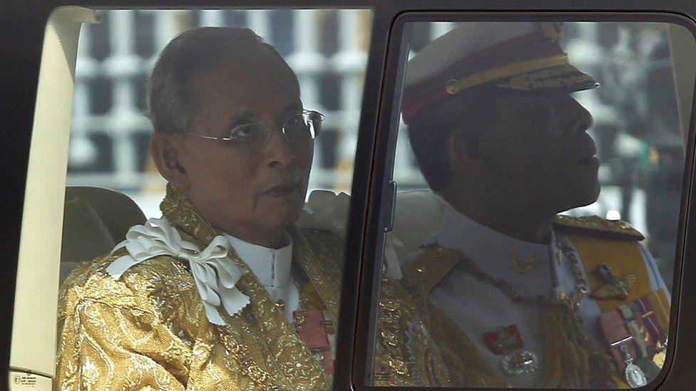 Thailand's King Bhumibol Adulyadej (L) looks out of a window of a van next to Crown Prince Maha Vajiralongkorn as they return to Siriraj Hospital in Bangkok 5 December 2012.