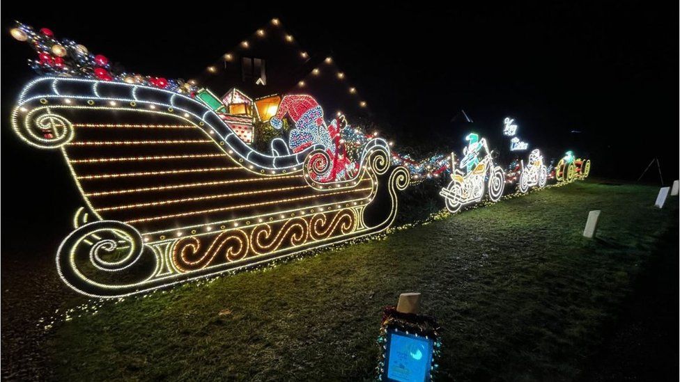 Photo of Christmas lights making up Santa's sleigh with reindeer