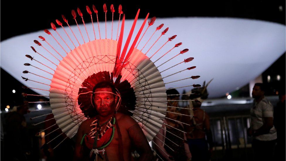 Indigenous men take part in a protest to defend indigenous land and cultural rights
