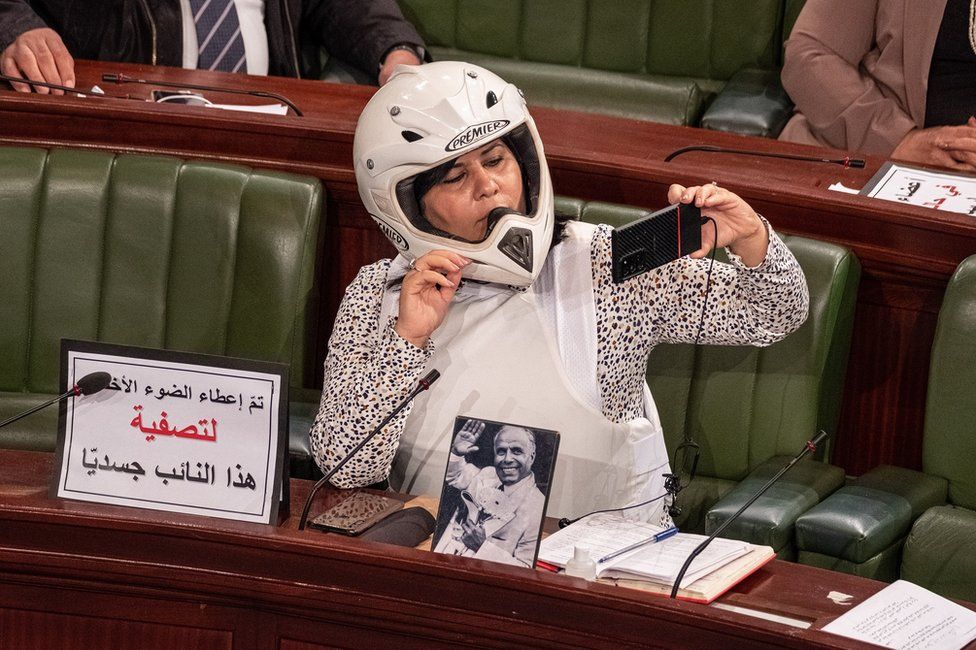 Abir Moussi wearing a helmet and a flak jacket in parliament