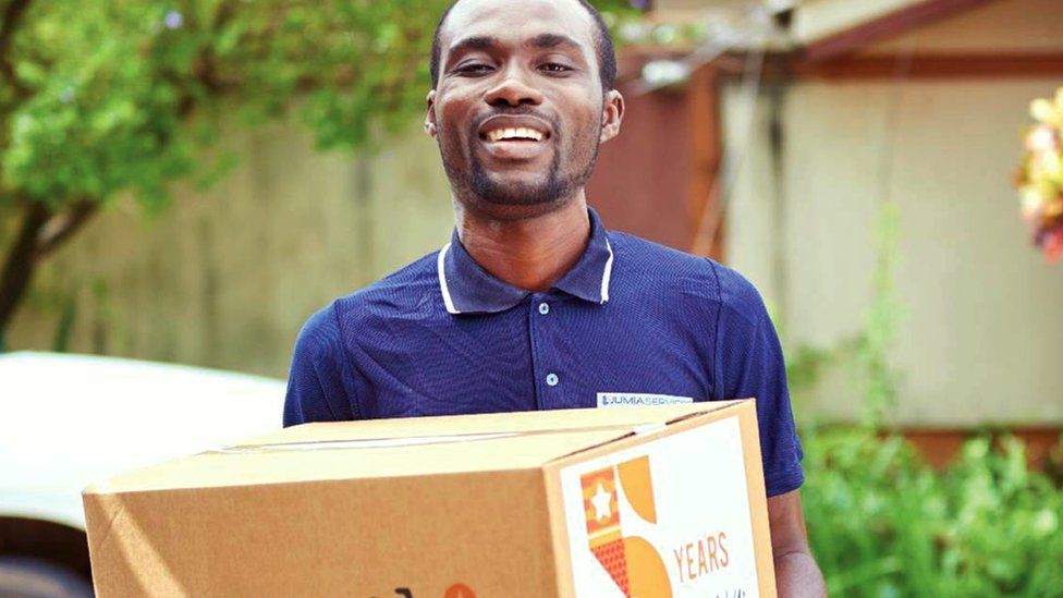 A Jumia delivery person with a box