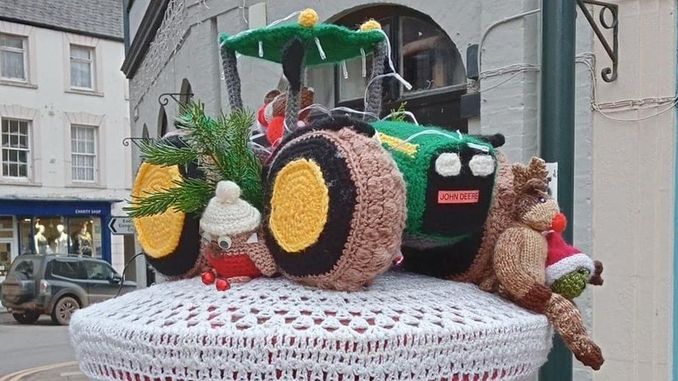 A knitted tractor on a postbox