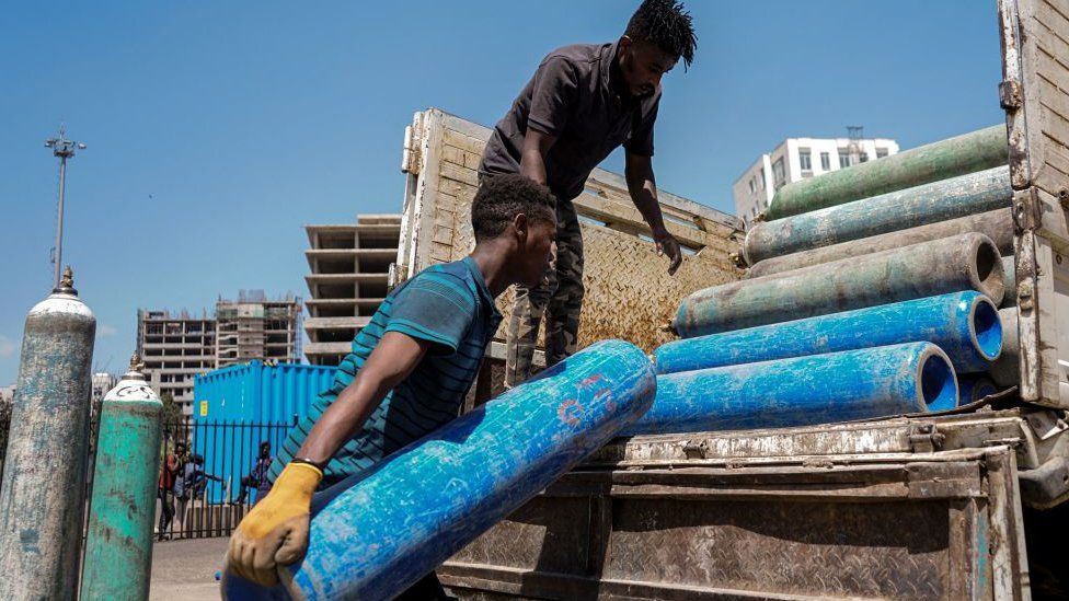 Staff members loads empty oxygen cylinders on a truck to refill at the makeshift hospital installed inside Millenium Hall, one of the country's largest event center in Addis Ababa, Ethiopia, on March 19, 2021.