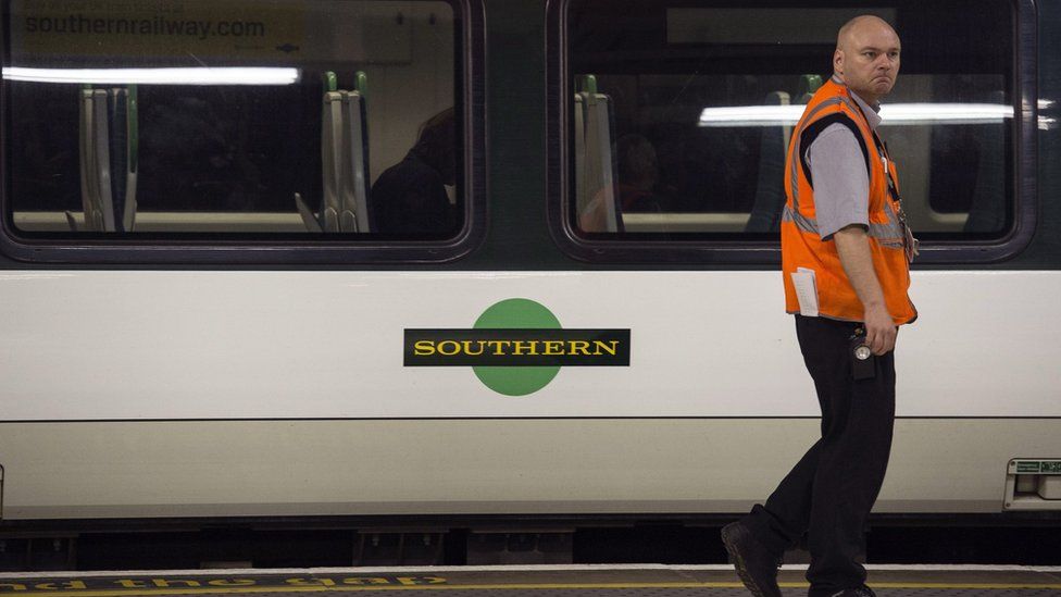 An employee walks past a train during a strike