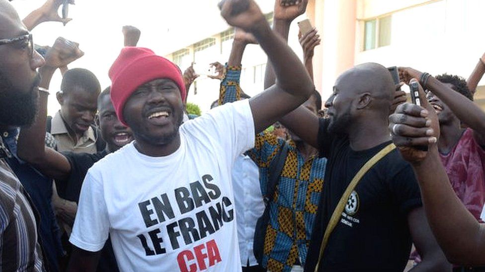 Supporters celebrate in a street of Dakar after the courthouse has decided to release activist Kemi Seba from the Rebeuss jailhouse on August 29, 2017. Kemi Seba was arrested after he burned a 5,000 CFA franc bank note during a meeting on August 19, 2017