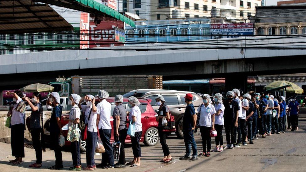 People queue to be tested for Covid-19 at a seafood market in Samut Sakhon on December 19, 2020