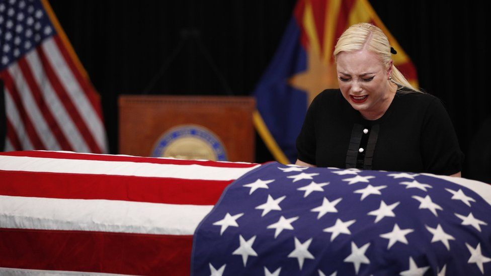 Meghan McCain, daughter of Senator John McCain, cries over his coffin