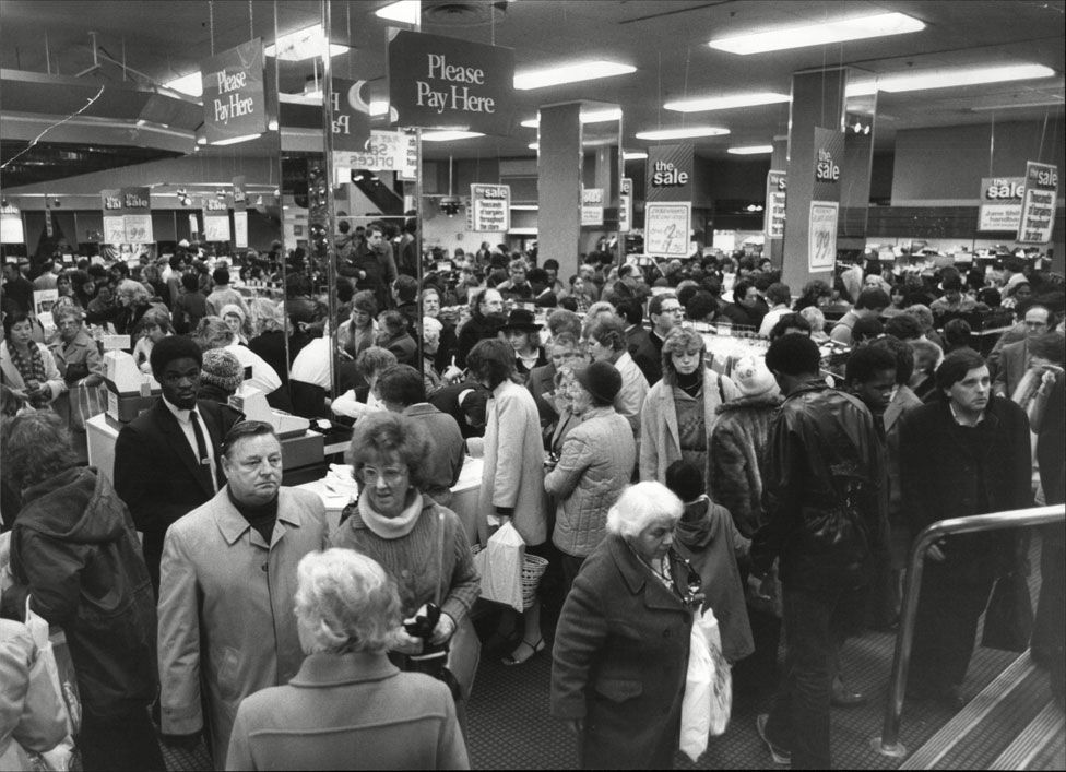 A crowd of shoppers in a Debenhams store