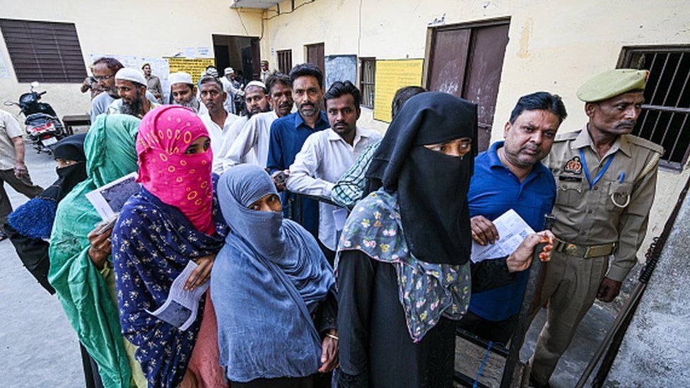 Voters queue at a polling station during the first phase of voting for national elections in Muzaffarnagar district, Uttar Pradesh, India, on Friday, April 19, 2024
