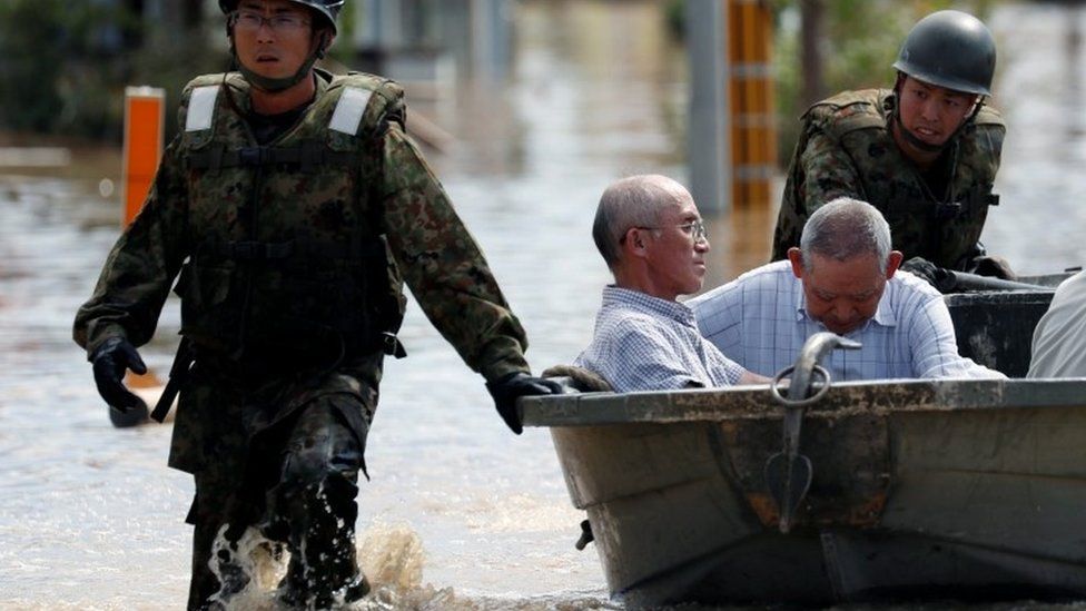 Japan Self-Defence Force soldiers rescue people from a flooded area in Mabi