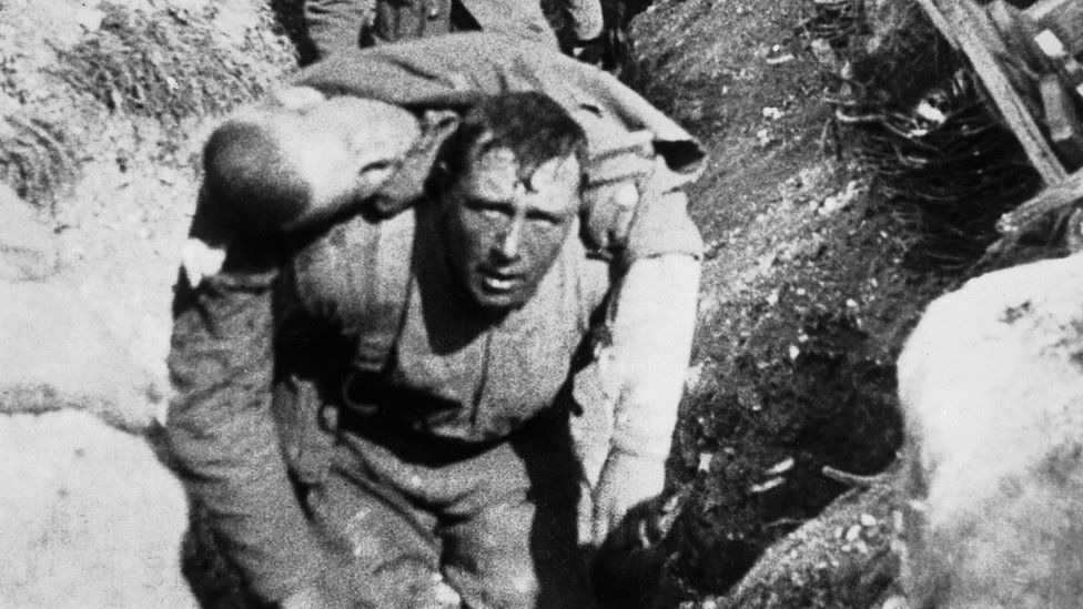A soldier carrying a wounded comrade on the first day of the Somme