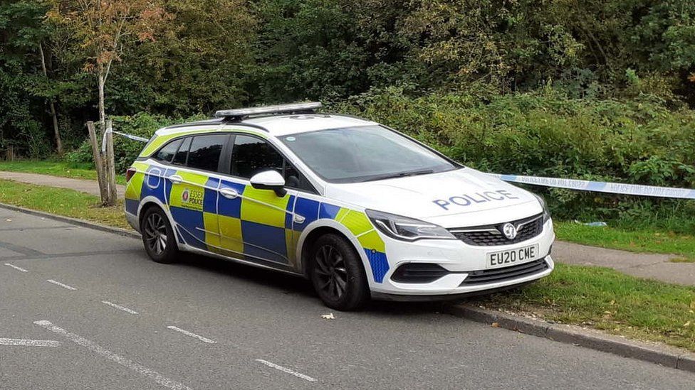 Police car at woodland near to the Oakwood Hill Industrial Estate in Loughton