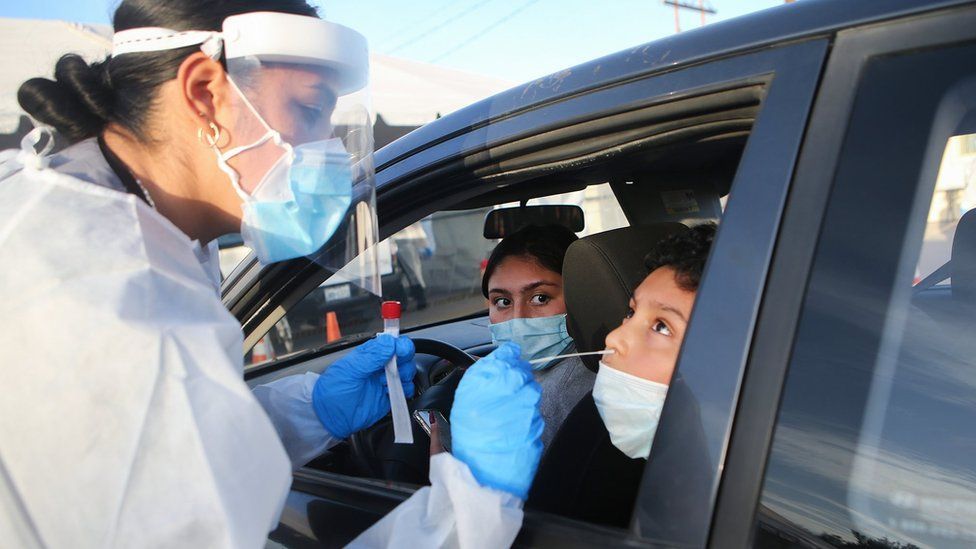 Frontline healthcare worker Joanne Grajeda administers a nasal swab test at a drive-in COVID-19 testing site amid a surge of COVID-19 cases in El Paso on November 13, 2020 in El Paso, Texas.