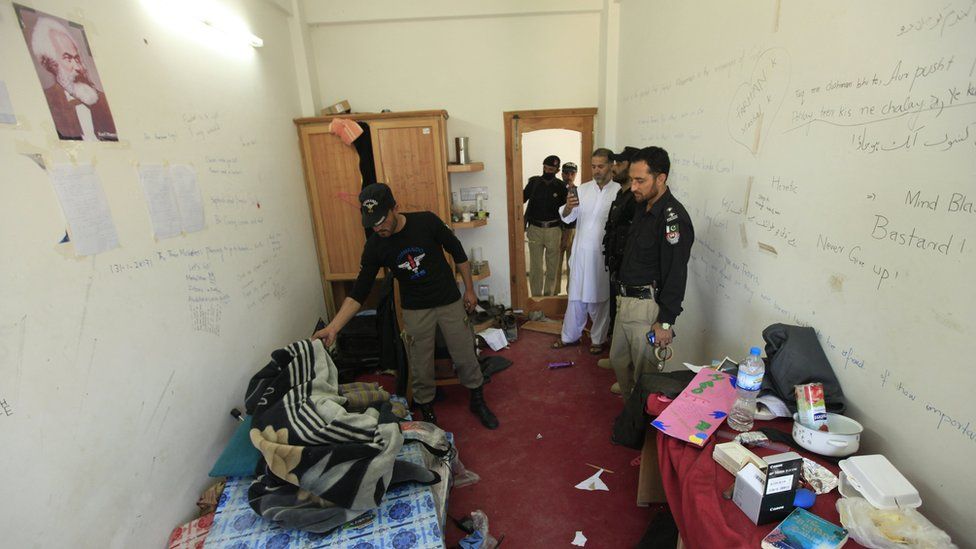 Pakistani security officials survey the room of student Mashal Khan at Abdul Wali Khan University, where he was killed by a mob of his fellow students for alleged blasphemy in Mardan