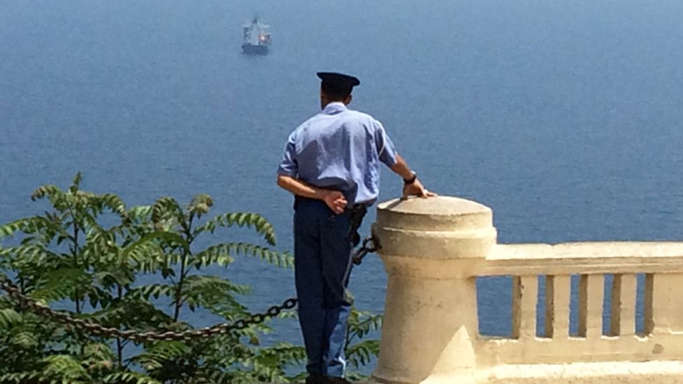 Policeman looking out to sea