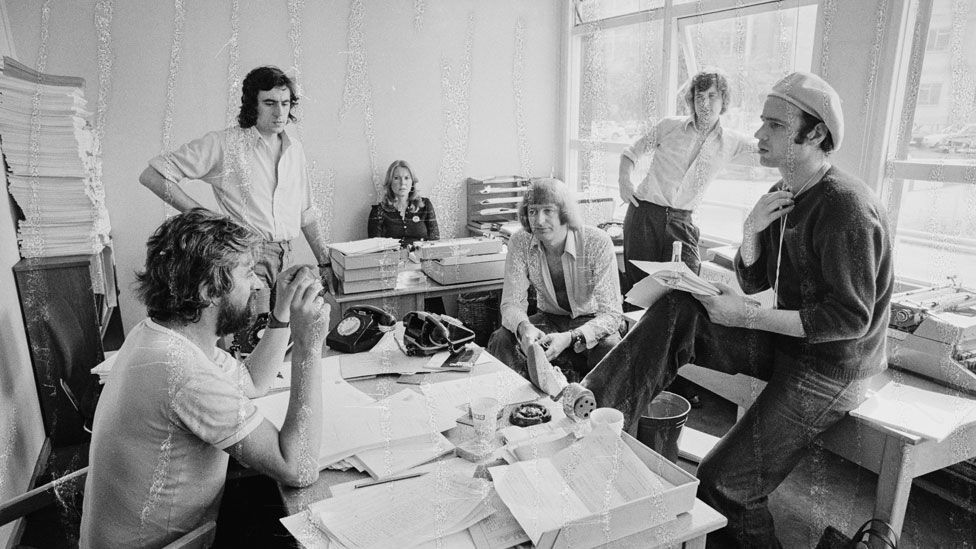 Neil Innes (right in hat) in a script conference for BBC television show Monty Python's Flying Circus in 1974