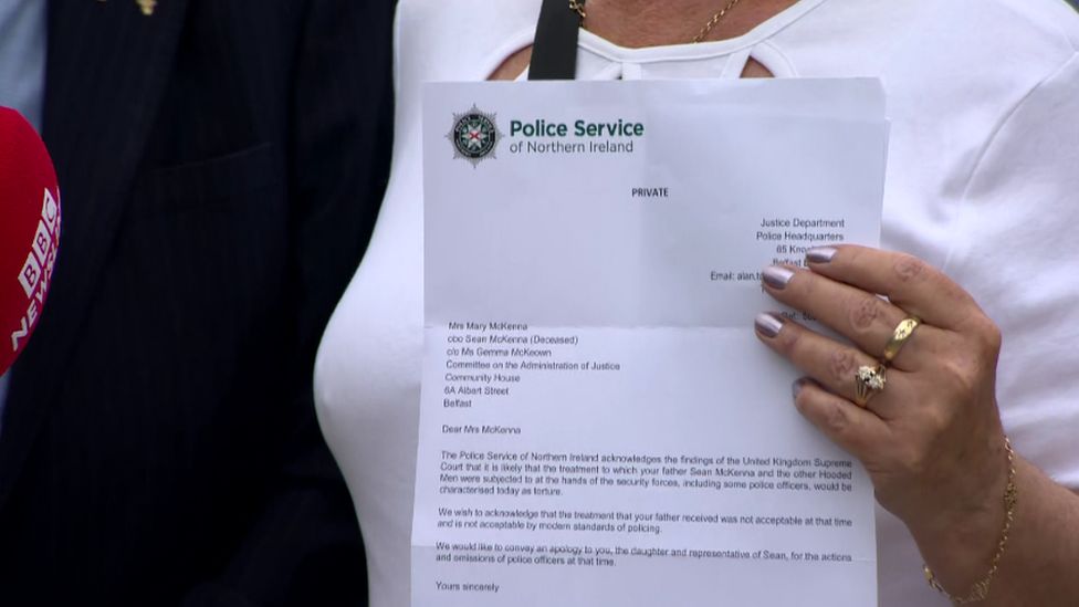 A family member holds up the letter from the PSNI