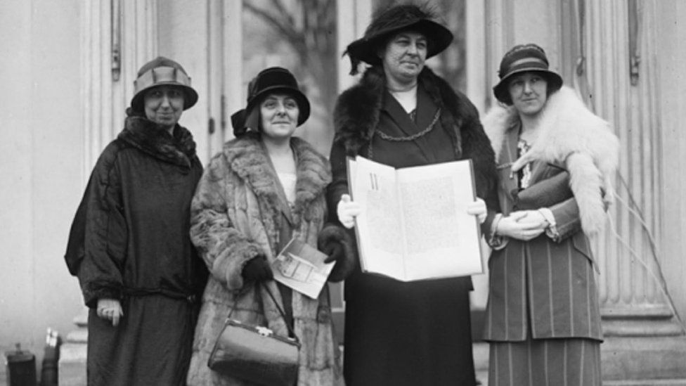 black and white photo of women in 1924 holding a petition