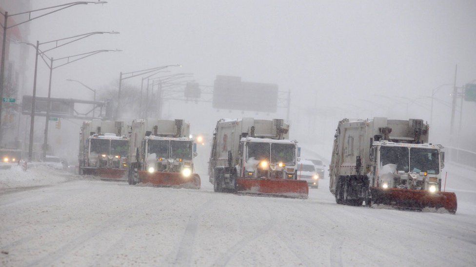A convoy of plough trucks in New York clear roads