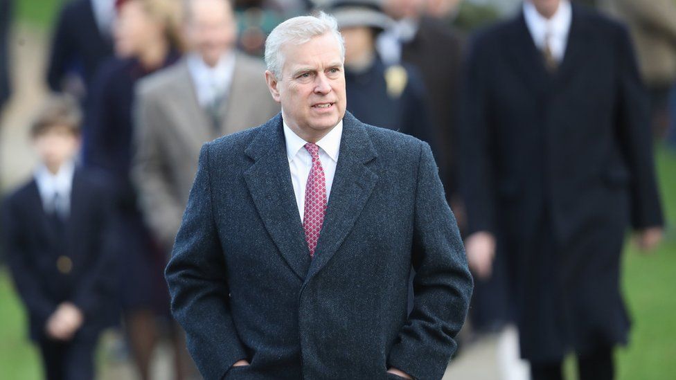Prince Andrew walks alongside his brother to attend the carol service