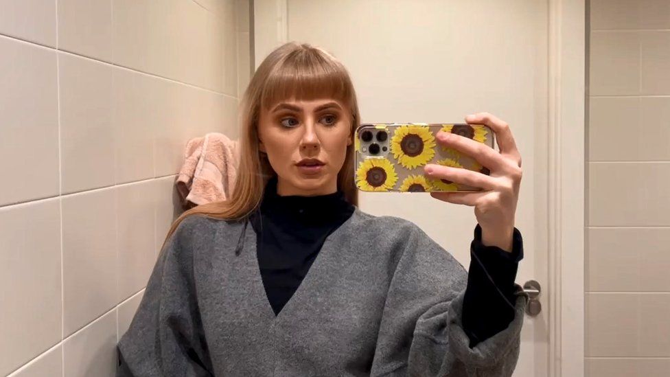 Heather MacFarlane taking a selfie photograph in a mirror