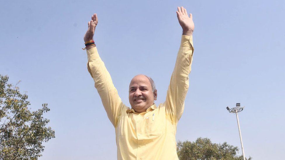 Delhi Deputy Chief Minister Manish Sisodia waves to the supporters at Rajghat prior to leaving for the Central Bureau of Investigation (CBI) office for questioning in connection with the liquor policy case, on February 26, 2023 in New Delhi, India. Sisodia and others face corruption allegations linked to a liquor sale policy in the national capital.