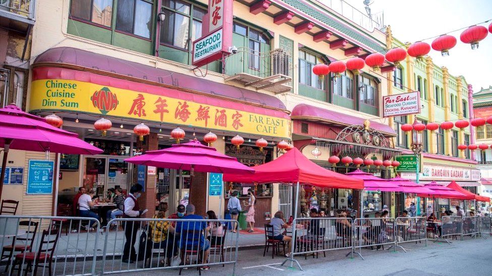 People eat outside a restaurant in San Francisco's Chinatown