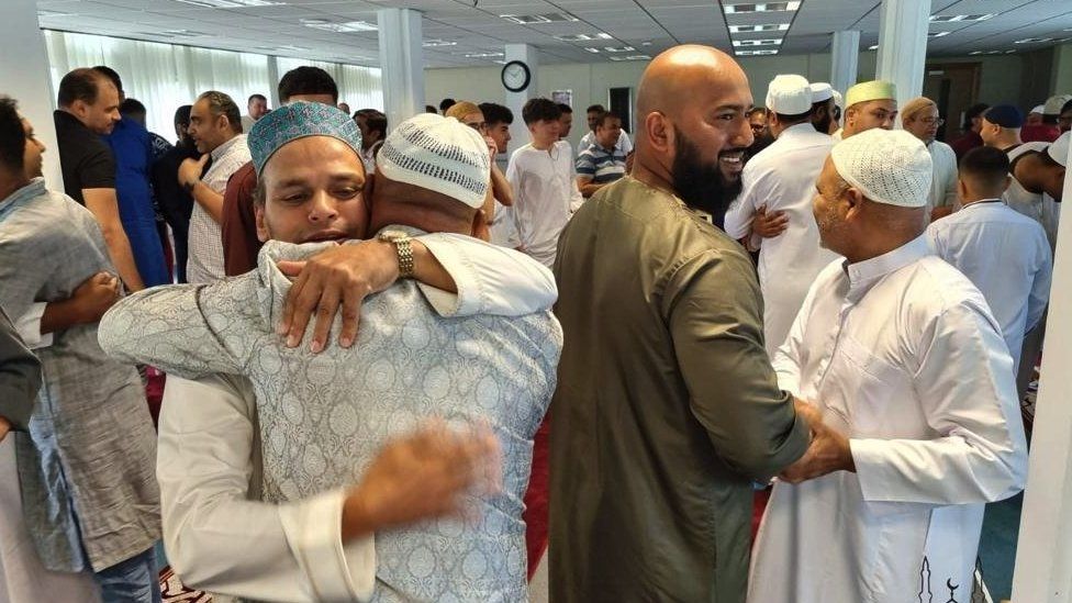 members of the community breaking a fast at an Iftar