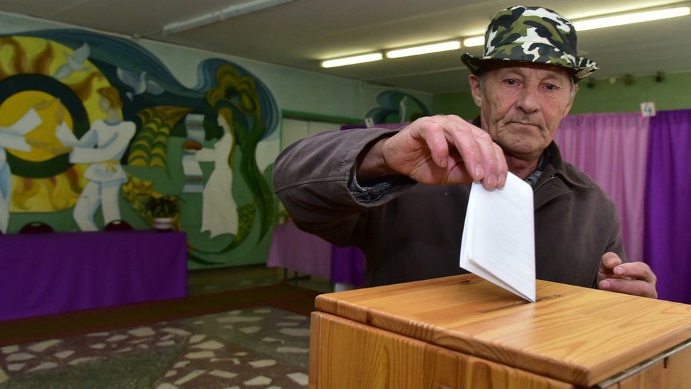 A man casts his ballot during pre-term presidential elections at a polling station in the Belarus' village of Dukora.